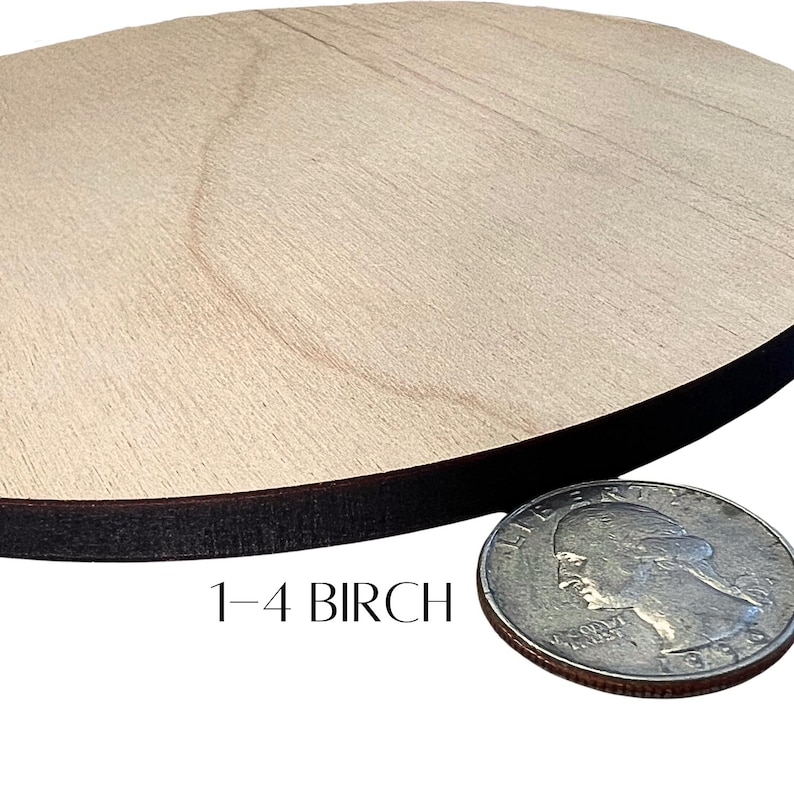 May include: A round, unfinished wooden disc with a dark brown edge. The disc is made of light-colored birch wood. The text "1-4 BIRCH" is printed in black. A U.S. quarter coin is next to the disc for size comparison.