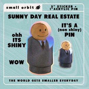 May include: A 3-inch sticker and a 1-inch acrylic pin featuring a cartoon character in a suit. The sticker has a holographic effect, while the pin is a non-shiny version. The text "Sunny Day Real Estate" is at the top of the image, and the text "The World Gets Smaller Everyday" is at the bottom.