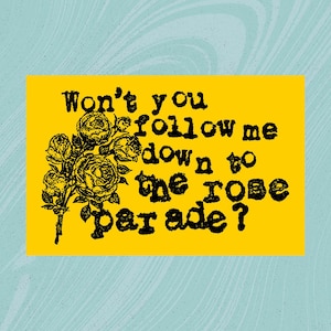 May include: A yellow rectangle with the text "Won't you follow me down to the rose parade?" in black, with a floral illustration. The background is a light blue with a textured pattern.