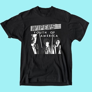 May include: Black t-shirt with a white graphic print of the band "Wipers" and the text "Youth of America".