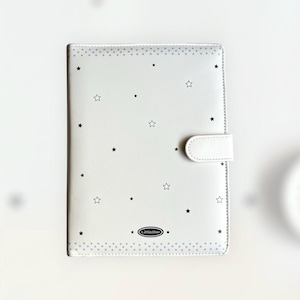 May include: A white notebook cover decorated with black stars. The cover features a white clasp closure and the text "Littlestar" at the bottom. The edges are lined with small grey dots.