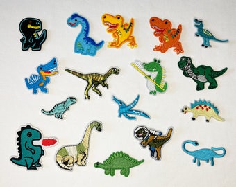 May include: A set of 15 colorful embroidered iron-on patches featuring various dinosaur designs. The patches are perfect for adding a fun and whimsical touch to clothing, bags, or other fabric items.
