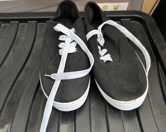 Black pumps with white shoelaces