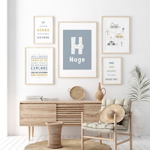 Quatre impressions encadrées avec du texte inspirant et un fond bleu. Les impressions présentent les mots "Héros", "Hugo", "Explorer" et "Créer, jouer, inventer et s'amuser".