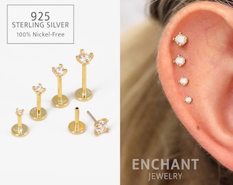 May include: A set of five gold-toned ear cartilage piercing studs with clear cubic zirconia stones. The studs are shown on a white background and on a model's ear. The text "925 STERLING SILVER 100% Nickel-Free" is shown on the white background. The text "ENCHANT JEWELRY" is shown on a tan background.