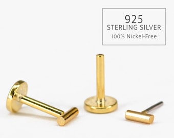 May include: Three gold-colored body jewelry pieces, including a barbell with a flat end and a round end, a barbell with a flat end and a straight end, and a straight barbell with a flat end. 925 Sterling Silver 100% Nickel-Free.