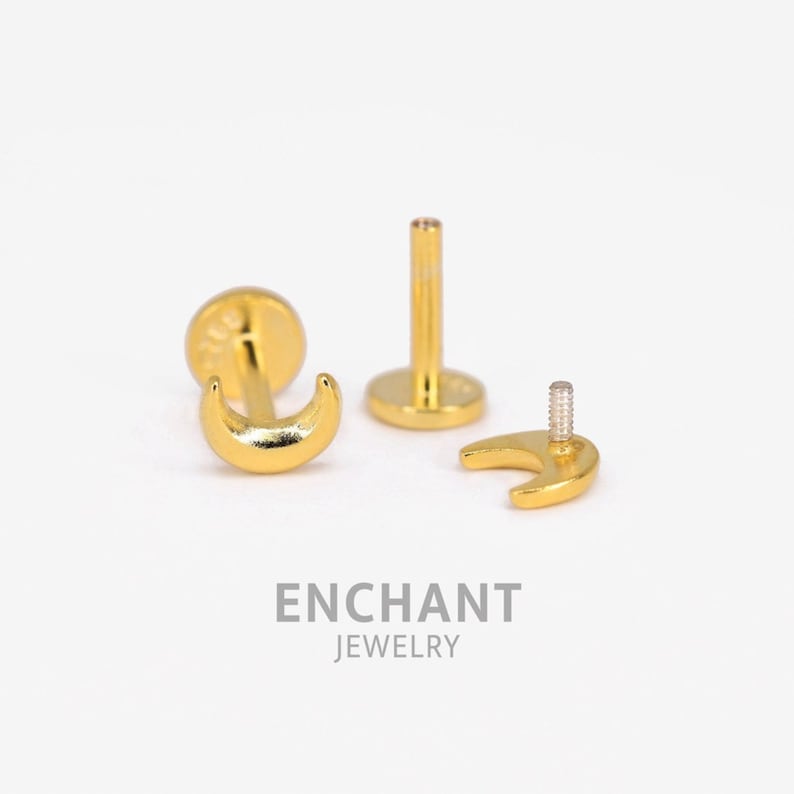 May include: Gold crescent moon shaped body jewelry for a cartilage piercing. The jewelry is made of surgical steel and is available in a variety of sizes.