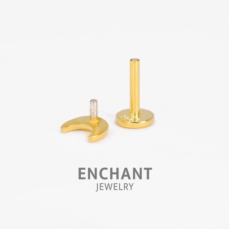 May include: Gold crescent moon shaped stud earring with a screw-on back. The earring is shown next to a gold post with a flat back.