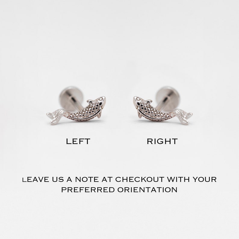 May include: Two silver fish earrings, one facing left and one facing right. The earrings are shown on a white background. Leave a note at checkout with your preferred orientation.