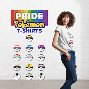 May include: A light grey t-shirt featuring two stacked Poké Ball graphics with horizontal stripes in various colours. Above the shirt, a sign displays the text PRIDE Pokémon T-SHIRTS over a rainbow background, with thirteen additional Poké Ball icons.