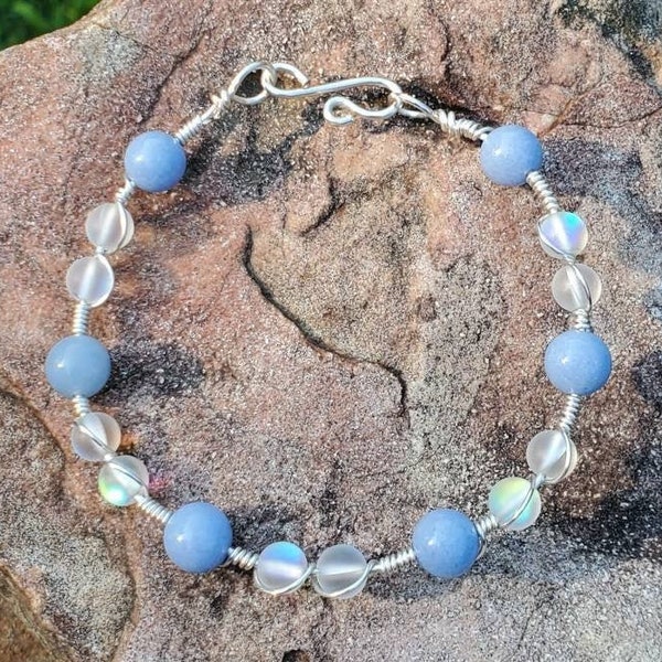 Silver Wire Wrap Bracelet with Blue Aragonite and Aura Quartz Beads. Glows in the dark a bright blue color