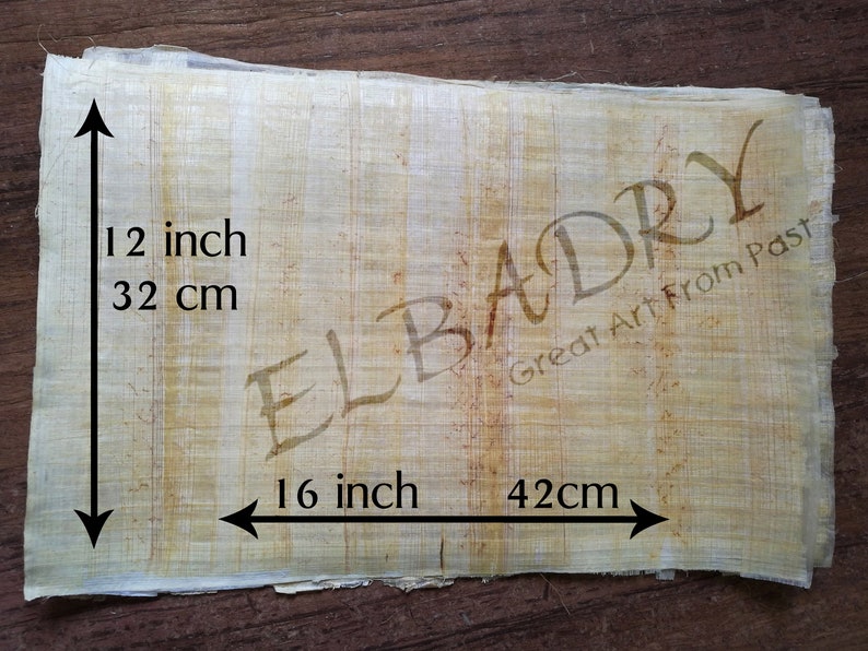 May include: A sheet of beige papyrus measuring 16 inches by 12 inches, or 42 cm by 32 cm. The papyrus has a natural, slightly rough texture. The words "ELBADRY Great Art From Past" are printed in brown ink in the upper right corner.