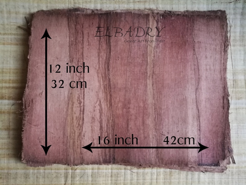 May include: A piece of brown papyrus paper with a reddish-brown stain. The paper measures 12 inches by 16 inches, or 32 cm by 42 cm. The text "ELBADRY Great Art From Past!" is printed on the paper.