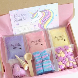 May include: A 'Unicorn Sparkle' potion play kit in a box, featuring packets of coloured powders, sweets, a wooden spoon, a seashell, and a pipette. The kit is presented in a pink-lined box with a unicorn illustration on the lid.
