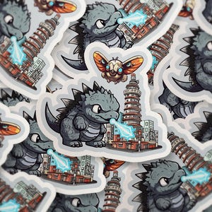 Chibi Godzilla & Mothra Sticker – Cute Kaiju Anime Decal for Laptop, Water Bottle, Journal, Tokyo City Art – Holo, Glitter, Matte Finish