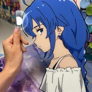 May include: A digital illustration of a young woman with long blue hair, wearing a white off-the-shoulder top. The woman is looking down and has a sad expression on her face.