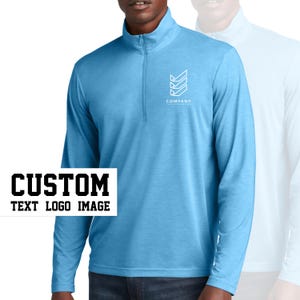 May include: A light blue long-sleeved shirt with a zippered collar. The shirt has a white geometric logo with the text "COMPANY" underneath. The text "CUSTOM TEXT LOGO IMAGE" is in black letters on a white background.