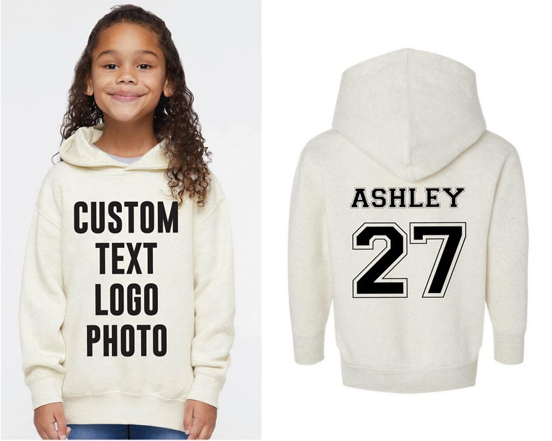 A young girl wearing a white hoodie with the text "CUSTOM TEXT LOGO PHOTO" printed on it, and the name "ASHLEY 27" printed on the back.