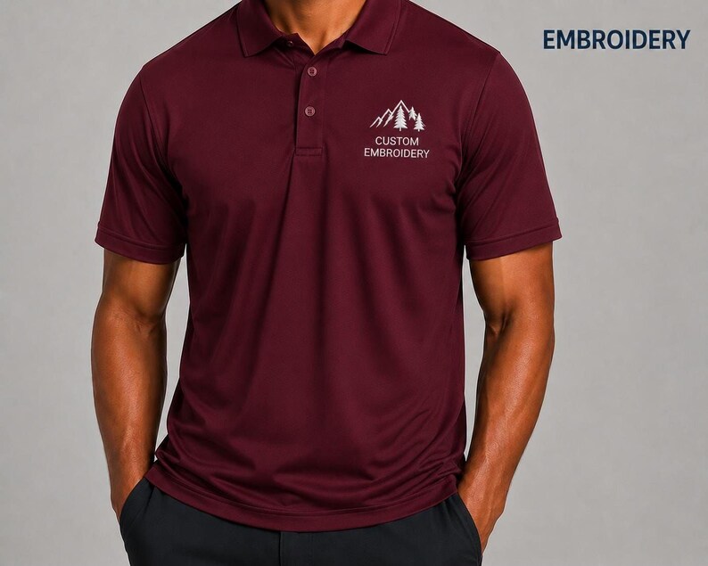 A man wearing a burgundy polo shirt with a logo on the left side of the chest.