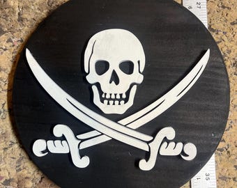 Jolly Roger Wood Wall Sign – 10” Pirate Skull & Crossed Swords Decor – Round Black Wooden Man Cave Sign – Nautical Pirate Wall Art