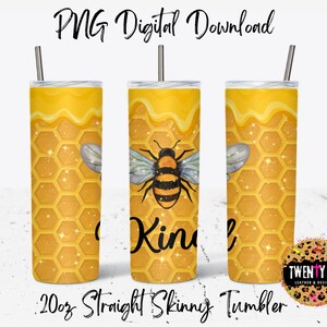 May include: A 20oz straight skinny tumbler with a design of a bee on a honeycomb background. The tumbler is yellow with a dripping honey effect. The text "Kind" is on the tumbler.