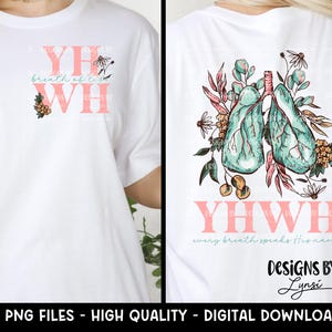 May include: A white t-shirt with a pink graphic design that says "YH breath of life WH" on the front and a pink graphic design that says "YHWH every breath speaks His name" with a teal and pink illustration of lungs surrounded by flowers on the back. The design also includes the text "Designs by Lynsi".