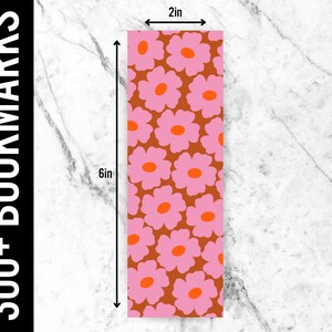 May include: A bookmark with a pink and orange floral pattern on a brown background. The bookmark is 6 inches tall and 2 inches wide.