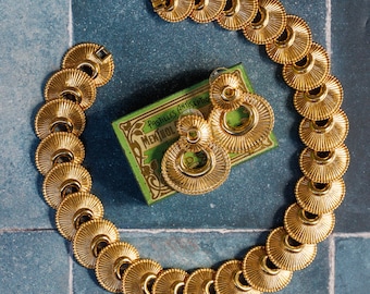Monet Gold-plated jewelry set: Statement choker, pierced earrings, and chunky bracelet from the 1960s.