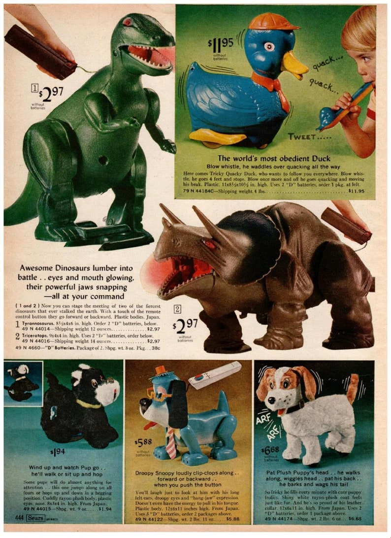 May include: Vintage toy advertisement featuring several battery-operated toys. A green Tyrannosaurus Rex and a brown Triceratops are displayed. A blue duck toy with an orange hat and a white dog toy are also shown. The toys are from Japan.