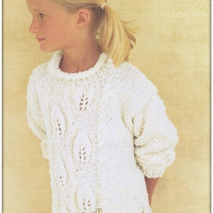 May include: A white knitted sweater with a cable knit pattern and a delicate lace design. The sweater has a round neckline and long sleeves.