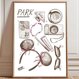 May include: A framed print featuring a sketch of park essentials. The illustration includes a Magic Pass, a bracelet, a camera, sunglasses, a coffee cup, a perfume bottle, and Mickey Mouse ear headbands with pink bows. Text reads "PARK essentials" and "Pixie Dust POST".