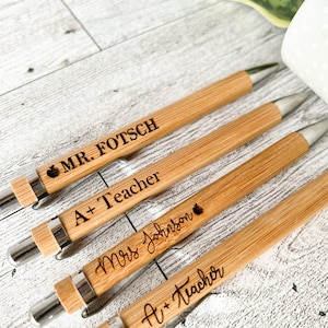 Two wood engraved teacher pens with gift tag