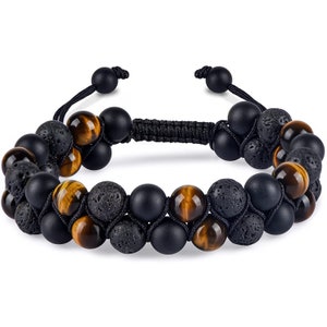May include: Double-strand bracelet featuring black lava rock, matte black onyx, and tiger's eye beads. The bracelet is adjustable with black cord and sliding knots. The beads are approximately 0.39 inches in diameter.