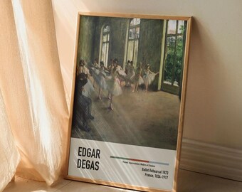 May include: A framed print of a painting by Edgar Degas titled "Ballet Rehearsal 1873". The painting depicts a group of ballerinas in a dance studio, practicing their moves. The painting is set in a room with large windows, and the light streaming in creates a sense of movement and energy.