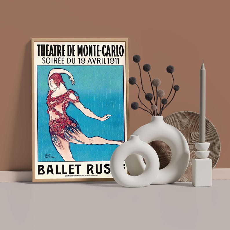 May include: A vintage poster advertising a performance of the Ballet Russe at the Theatre de Monte-Carlo on April 19, 1911. The poster features a dancer in a red and white costume with a blue background.