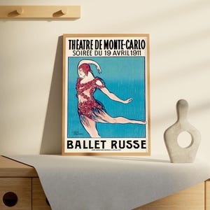 May include: A vintage poster advertising the Ballet Russe performance at the Theatre de Monte-Carlo on April 19, 1911. The poster features a dancer in a red and white costume against a blue background.