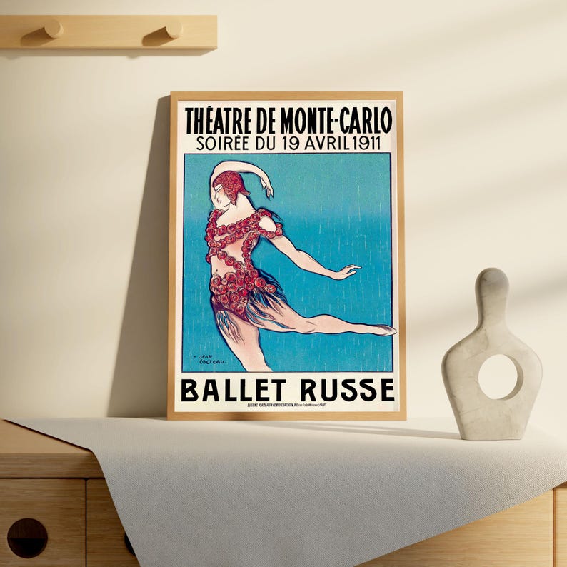 May include: A vintage poster advertising the Ballet Russe performance at the Theatre de Monte-Carlo on April 19, 1911. The poster features a dancer in a red and white costume against a blue background.