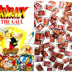 May include: A book cover featuring a cartoon illustration of Asterix, a Gaul warrior, kicking a Roman soldier. The title "Asterix The Gaul" is written in yellow and red letters. The book cover is white with a yellow background.