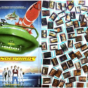 May include: A movie poster for the film "Thunderbirds" featuring a green spaceship with red and white rockets in the background. The poster also features a group of five people standing in front of a frozen lake.