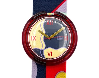 May include: A Swatch Pop watch with a burgundy case and a colorful patterned band. The watch face features Roman numerals and gold hands. The band is a mix of navy blue, red, and patterned sections.