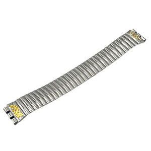 May include: A silver-toned, ribbed watch band with gold-colored decorative accents. The band is made of flexible metal links and features a repeating pattern. The gold accents are on the ends of the band.