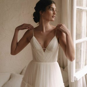 Custom wedding dress for bride. Sexy A-line straps wedding dress. Light white tulle wedding dress with deep V neck and open back.