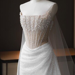 Luxurious beaded mermaid wedding dress. Sexy strapless wedding dress. Corset wedding dress with high-end underwire system.