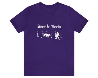 May include: Purple t-shirt with white text that says "Smooth Moves" and a graphic of a person and dog doing agility.