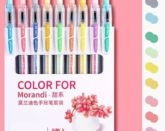 May include: A set of nine gel pens in a variety of pastel colors. The pens are arranged in a box with a white background and the text "COLOR FOR Morandi - 甜系 莫兰迪色手账笔套装 | 9枚入" printed on the front. The pens are labeled "Inoranges Color Gel" and have a clear barrel with a metallic finish.