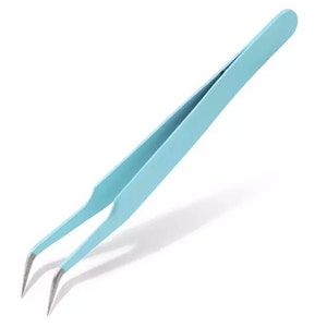 May include: A pair of light blue tweezers with slanted tips. The tweezers are made of metal and have a matte finish.
