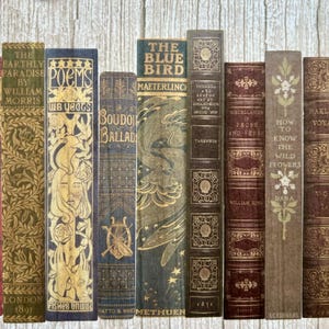 May include: A collection of vintage hardback books with ornate designs and gold lettering. The titles include "The Earthly Paradise", "Poems", "Boudoir Ballads", "The Blue Bird", "Twixt Land and Sea", "Miscellanies in Prose and Verse", "How to Know the Wild Flowers", "Hakluyt's Voyages", and "The Scottis Chief".