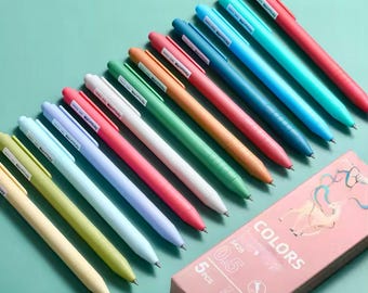 May include: A set of 10 colorful pens with a pastel color scheme. The pens are arranged in a row, with the tips of the pens facing the right side of the image. The pens are labeled with the word "COLORS" and the number "0.5".