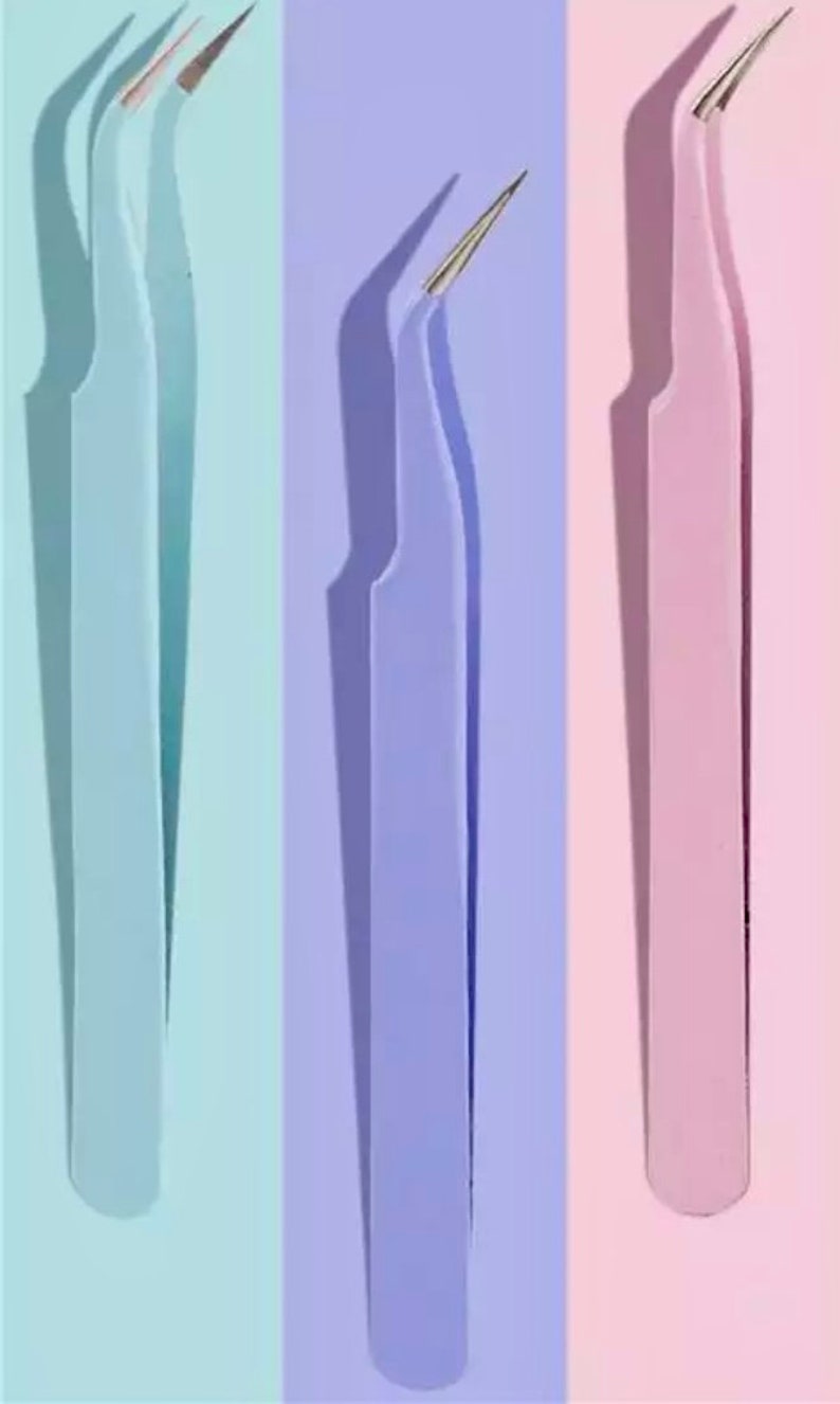 May include: Three pairs of tweezers with curved tips. The tweezers are light blue, lavender, and pink.