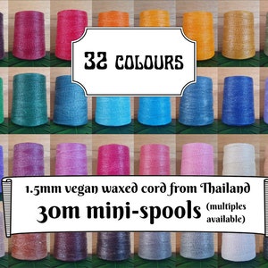 May include: An assortment of 32 mini-spools of 1.5mm vegan waxed cord in a range of colours. The spools are displayed in rows, presenting a variety of shades from dark purple to light beige. The image includes the text "32 COLOURS" and "30m mini-spools".